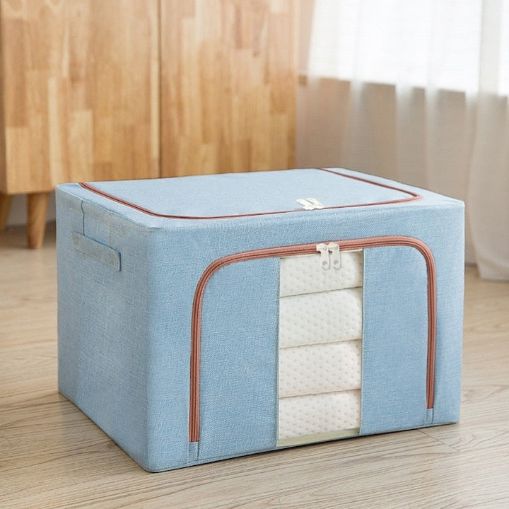 Organizator depozitare Macvi® 100 litri, cutie textila pliabila cu capac si fermoar, panou transparent pentru vizualizare si cadru metalic robust, ideala pentru haine voluminoase si depozitare