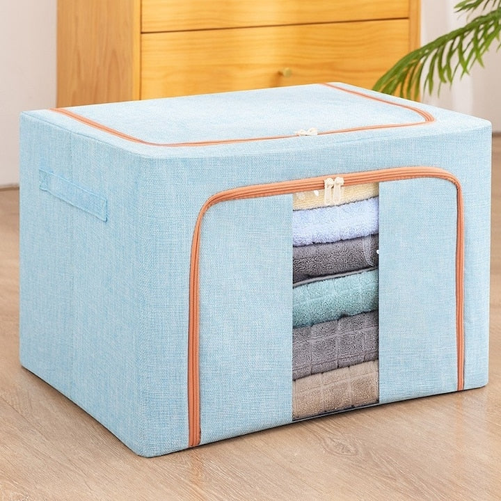 Organizator depozitare Macvi® 100 litri, cutie textila pliabila cu capac si fermoar, panou transparent pentru vizualizare si cadru metalic robust, ideala pentru haine voluminoase si depozitare